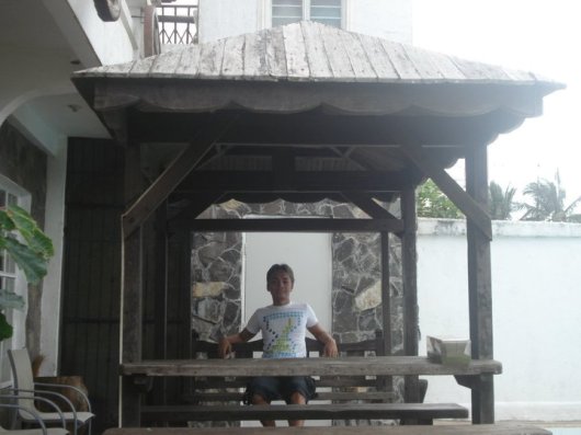 Swing bench and picnic table behind kitchen.
